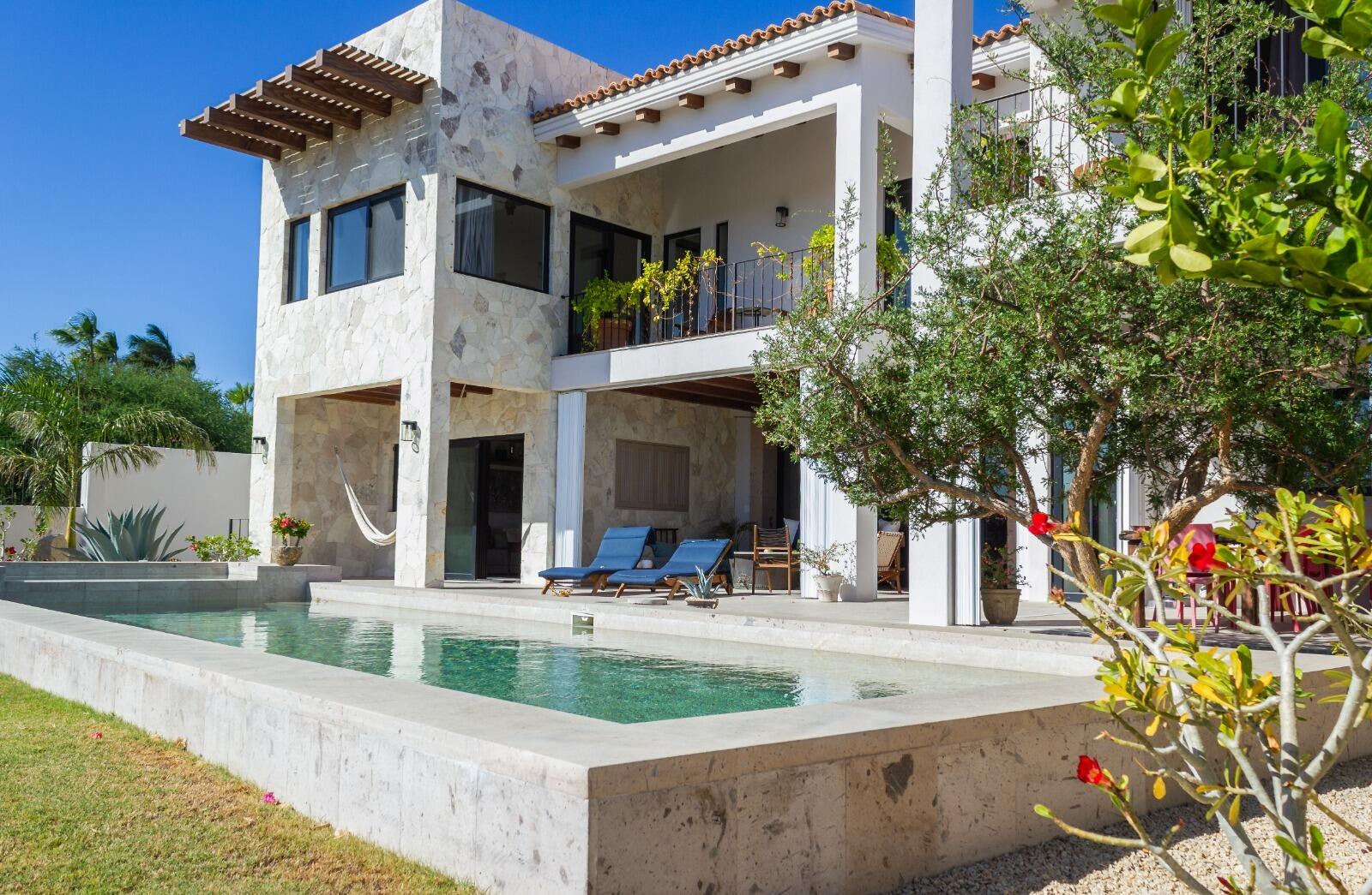 Cabo Golf La Caleta A once-in-a-generation legacy estate, never before on the market, this iconic beachfront residence offers incomparable prestige on the sands of Palmilla Bay, one of Cabo's most coveted and swimmable beaches. Set on a rare half-acre parcel directly on the water, the home features six bedrooms, six and a half baths, plus a full attached apartment, all executed in classic Palmilla style with timeless elegance and modern comfort. From the moment you enter, the architecture reveals its intention: a grand foyer flows effortlessly into an open living area and bar, framed by soaring ceilings and vast windows that disappear into the Baja breeze. The interiors dissolve into the outdoors, unveiling a dramatic terrace that cascades to a manicured lawn, infinity-edged pool, waterslide, spa, and expansive entertaining pavilion designed for unforgettable gatherings beneath the stars.The second level hosts two principal suites, each opening to a vast private terrace with sweeping for sale