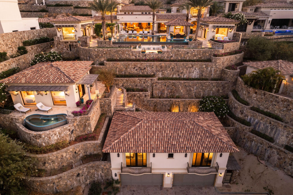 Cabo Golf Villas De Oro Phase 1 Villa de Oro fantastic. Number 304 is very unique as it is one of a few town homes (most are upper or lower)that has a massive dramatic two story window that lights up the home. Downstairs has the impressive living and dining room. The kitchen has a new granite counter, a breakfast area and a bar for guests to enjoy the activity in the kitchen. Outside living with a big space to dine and sit around the large stone fireplace. Upstairs there are two bedroom suites, one of which has an outside terrace to enjoy the ocean for sale