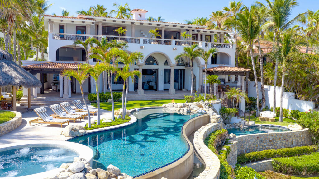 Cabo Golf La Caleta A once-in-a-generation legacy estate, never before on the market, this iconic beachfront residence offers incomparable prestige on the sands of Palmilla Bay, one of Cabo's most coveted and swimmable beaches. Set on a rare half-acre parcel directly on the water, the home features six bedrooms, six and a half baths, plus a full attached apartment, all executed in classic Palmilla style with timeless elegance and modern comfort. From the moment you enter, the architecture reveals its intention: a grand foyer flows effortlessly into an open living area and bar, framed by soaring ceilings and vast windows that disappear into the Baja breeze. The interiors dissolve into the outdoors, unveiling a dramatic terrace that cascades to a manicured lawn, infinity-edged pool, waterslide, spa, and expansive entertaining pavilion designed for unforgettable gatherings beneath the stars.The second level hosts two principal suites, each opening to a vast private terrace with sweeping for sale