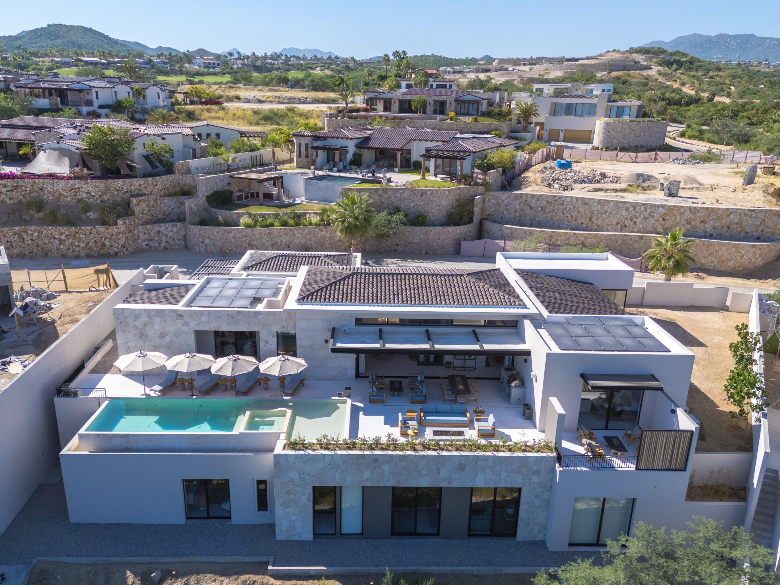 Cabo Golf Section 18- Horizontes Welcome to Horizontes 3, an exquisite custom-made home located within San José del Cabo's most sought-after community, Querencia. Surrounded by Tom Fazio's signature golf course, recognized as one of the best in the country, this stunning residence is just a short golf cart ride from the prestigious 5-star Club House. This remarkable 6-bedroom, 6.5-bathroom home elevates luxury living with a fresh vision of architecture and design. The layout features a cozy family room, an expansive bunk bed bedroom on the lower level, and a spacious maid's quarters with an independent entrance, making it ideal for entertaining family and friends.The property boasts outdoor living spaces, including tranquil green areas, an outdoor kitchen, an infinity pool, a jacuzzi, and ocean and ravine for sale